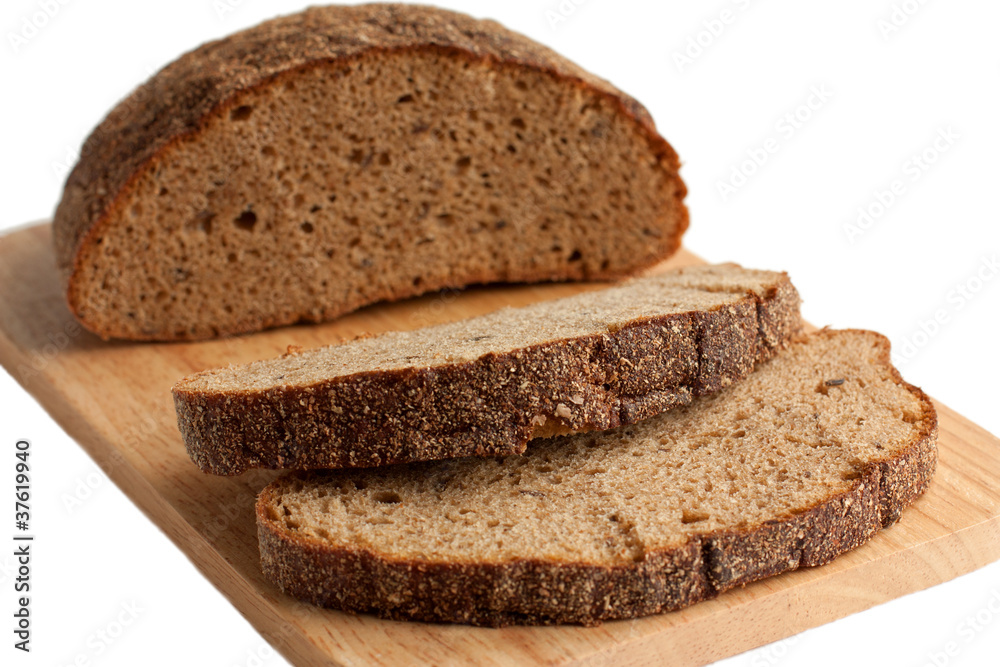 A delicious brown bread on the cutting board A delicious brown bread on the cutting board