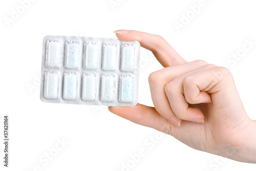 Obraz na plátně Blister with 10 chewing gums in hand isolated on white