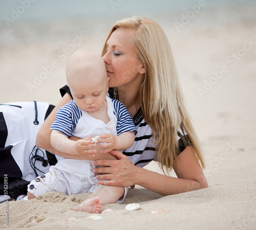 happy mother and baby playing on beach photo