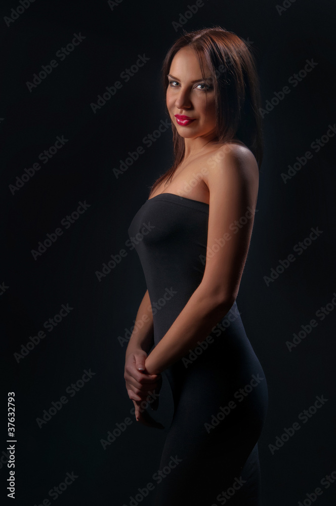 brunette girl posing on dark background brunette girl posing on dark background