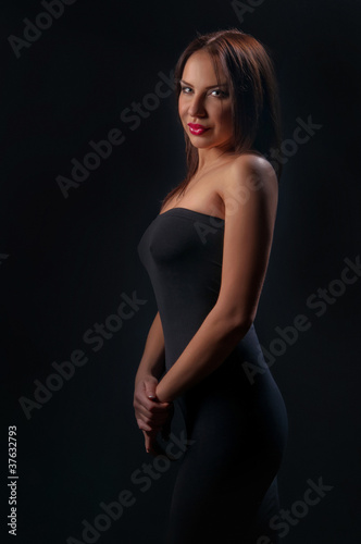 brunette girl posing on dark background