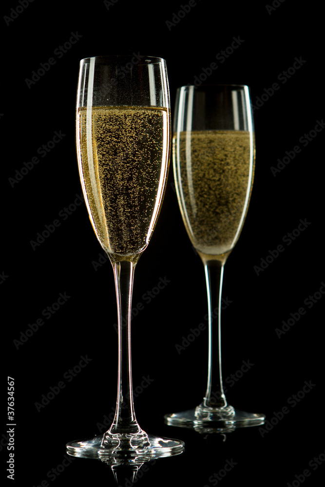 A glass of champagne, isolated on a black  background.