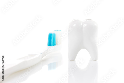 tooth and toothbrush isolated on white background