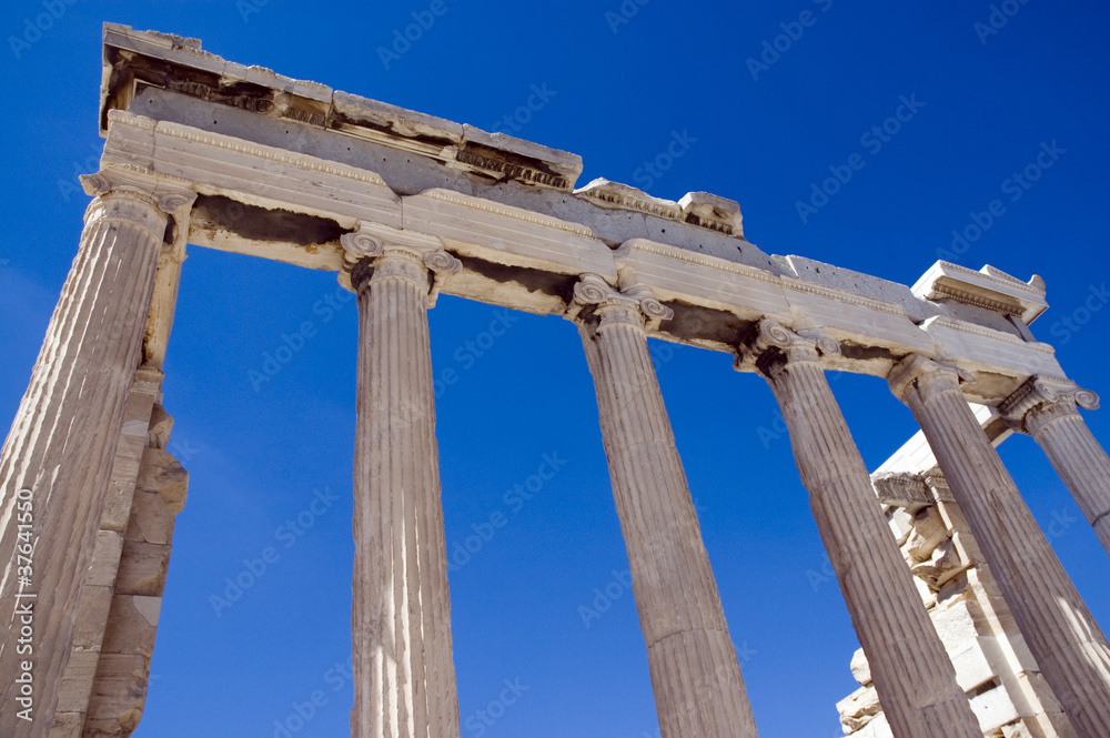 colums of the ruins of a greek temple under the blue sky
