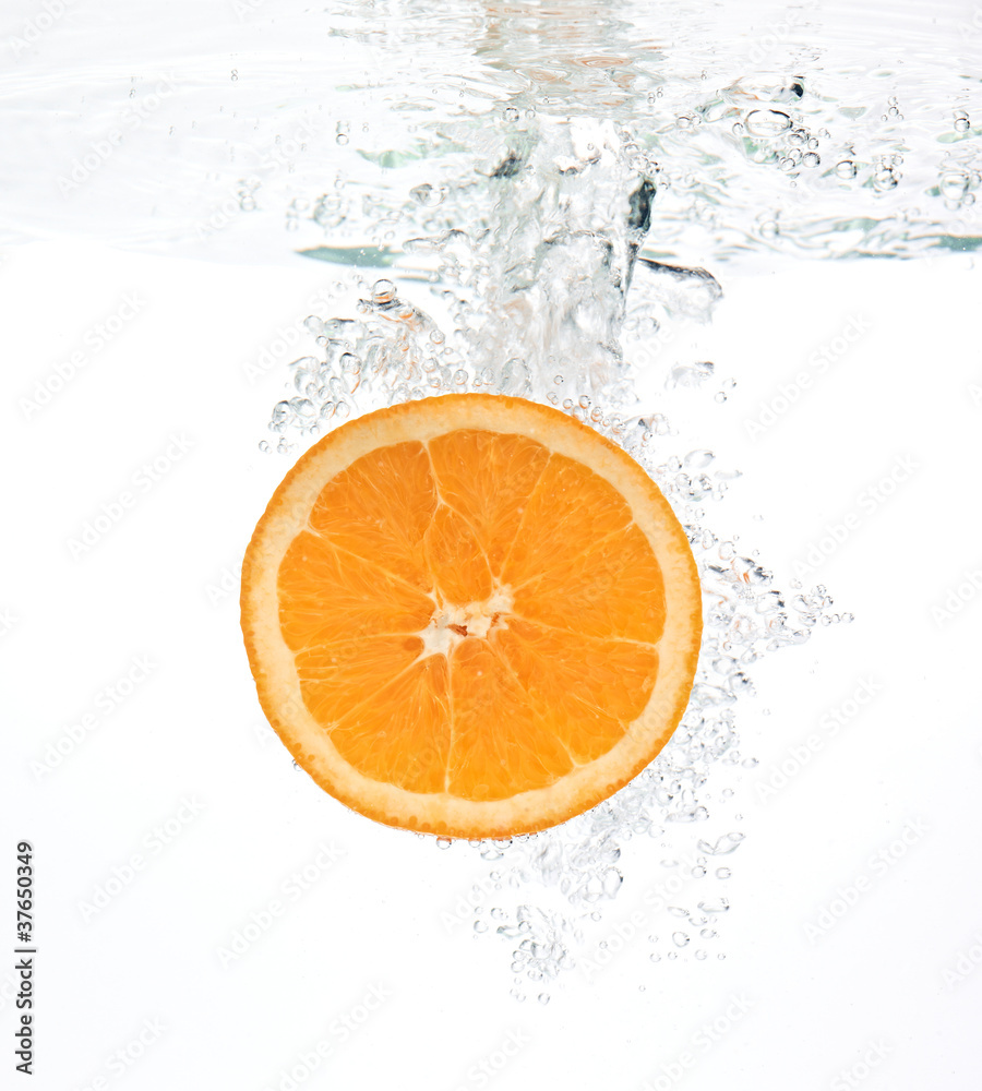 orange dropped into wather with splash orange dropped into wather with splash