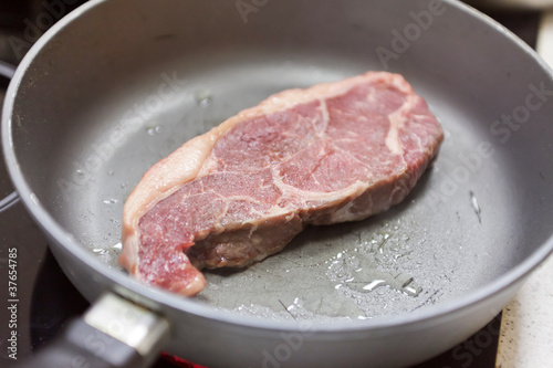 beef steak in a frying pan