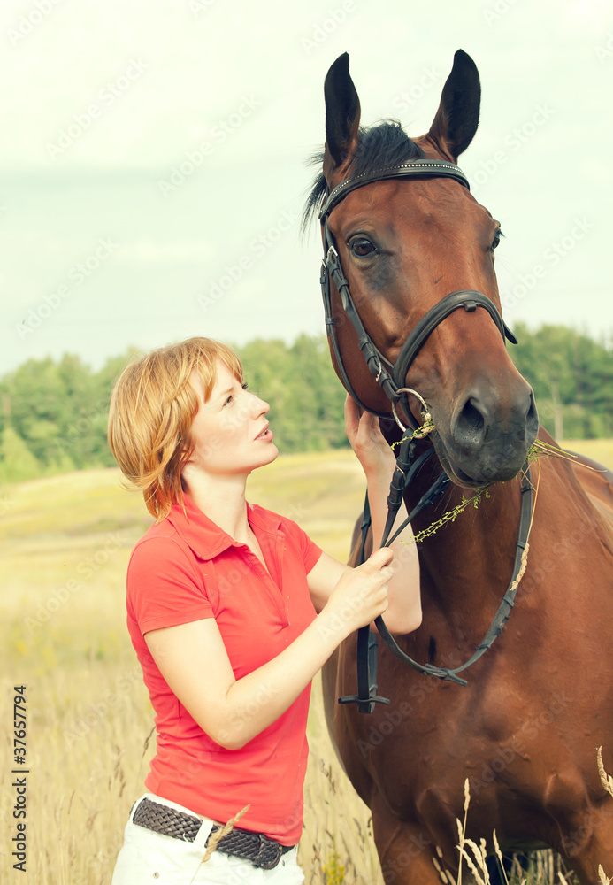 Obraz premium young pretty girl with her horse