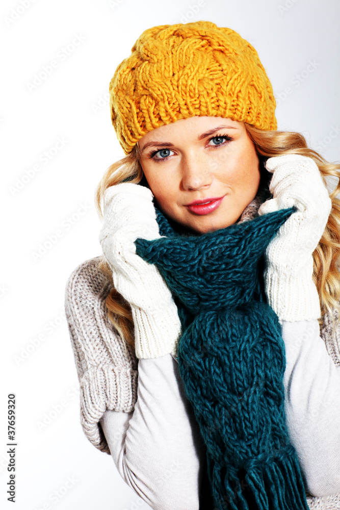Portrait of woman on white background wearing woolen accessories Portrait of woman on white background wearing woolen accessories