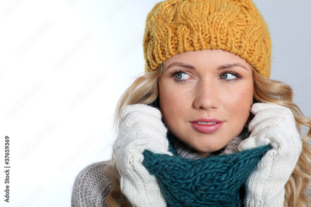 Portrait of woman on white background wearing woolen accessories Portrait of woman on white background wearing woolen accessories