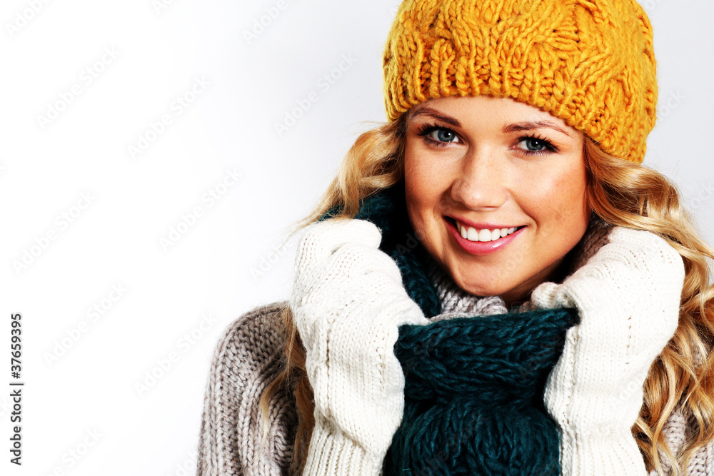 Portrait of woman on white background wearing woolen accessories Portrait of woman on white background wearing woolen accessories