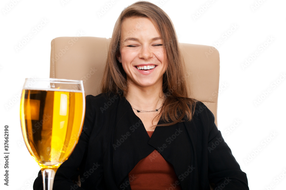 Businesswoman in leather chair with glass of cider laughing Businesswoman in leather chair with glass of cider laughing