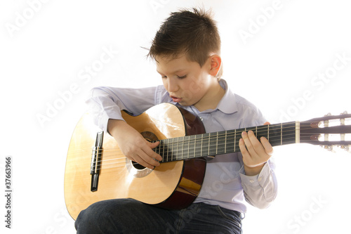 boy with an acoustic guitar isolated on white