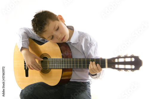 boy with an acoustic guitar isolated on white