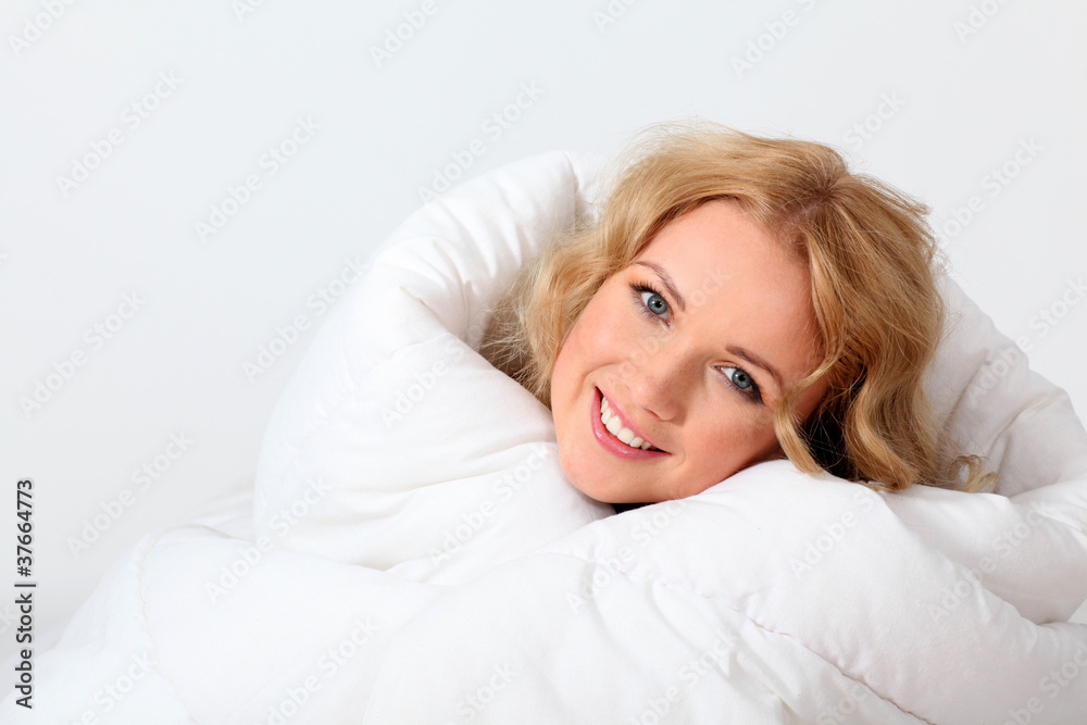 Portrait of beautiful woman in bed under blanket Portrait of beautiful woman in bed under blanket