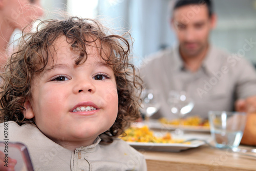 Fotografia Young girl having a meal with her family