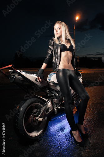 Young attractive woman and motorcycle