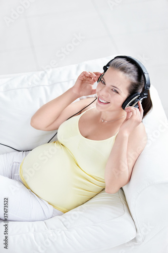 Pregnant woman with headphones