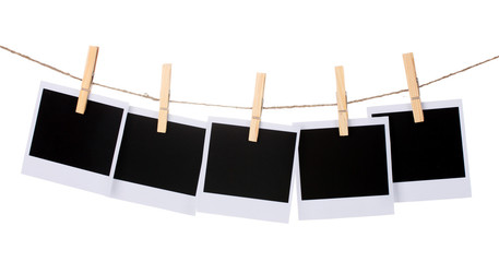 Photo paper hanging on the clothesline isolated on white