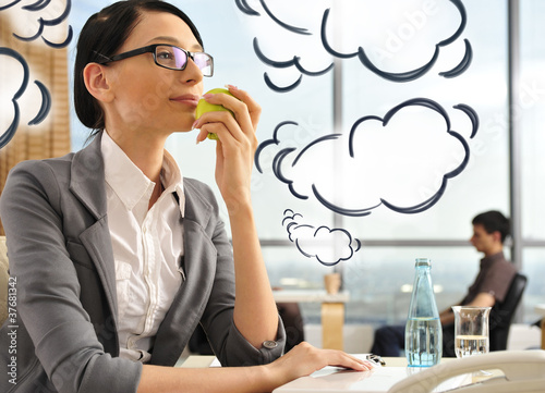 Portrait of a beautiful young businesswoman thinking. Office bac photo