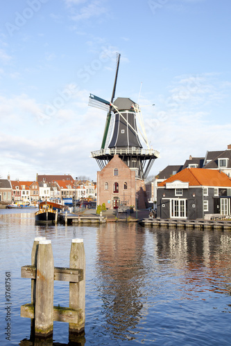 Classic windmill at canal in The Netherlands
