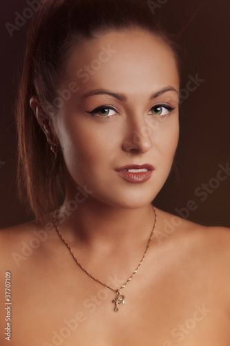 Young brunette lady posing on grey background