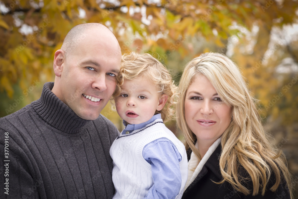 Young Attractive Parents and Child Portrait in Park Young Attractive Parents and Child Portrait in Park