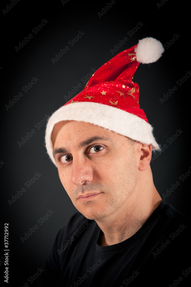 Man with fierce expression and christmas hat. Man with fierce expression and christmas hat.