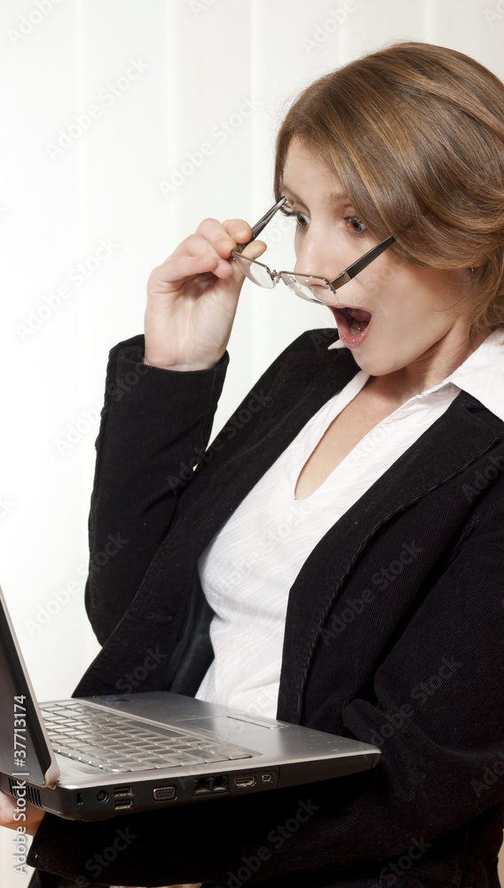 Surprised businesswoman looking at laptop Surprised businesswoman looking at laptop