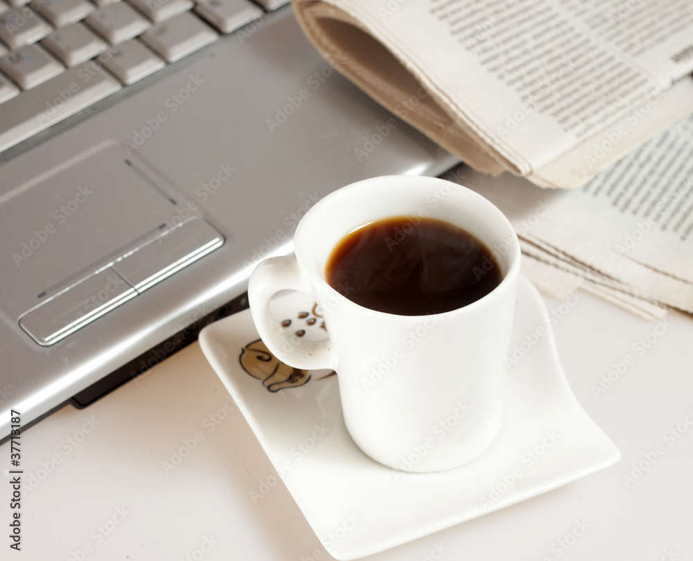 Coffee cup with laptop, glasses and newspaper Coffee cup with laptop, glasses and newspaper
