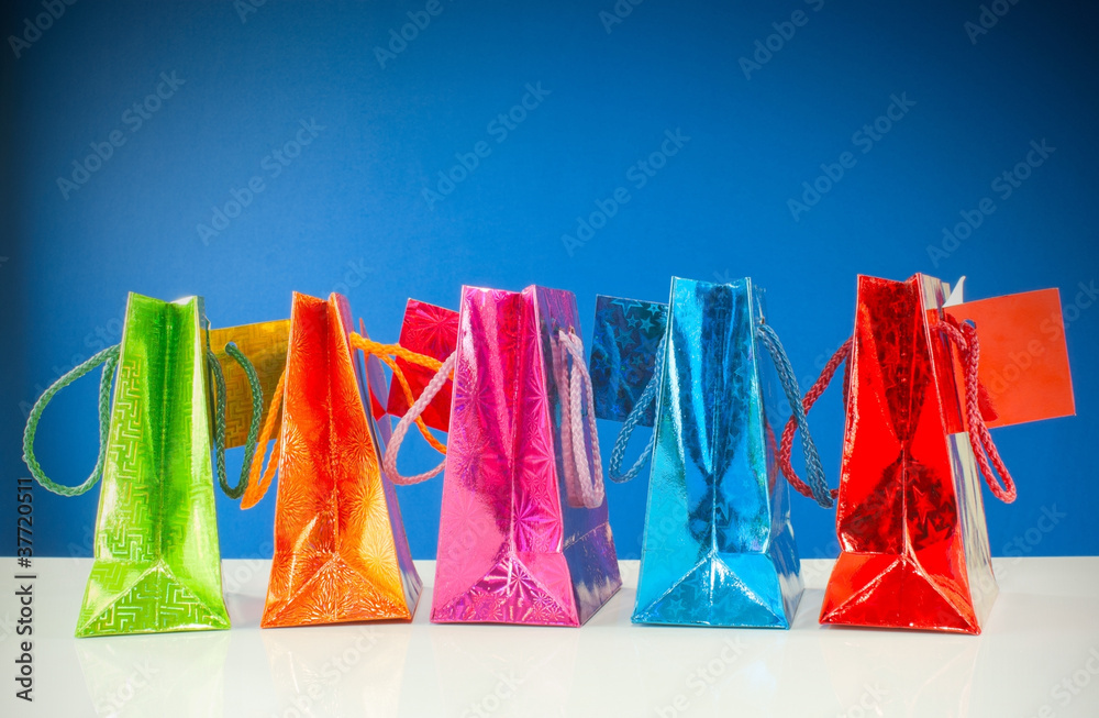Row of colorful bags against blue background