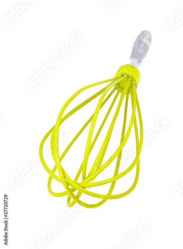 Green plastic whisk for whipping. Isolated on white background photo