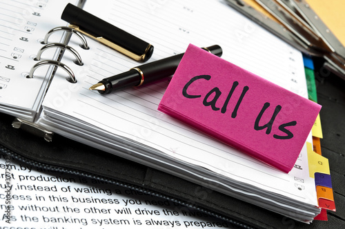 Call Us note on agenda and pen