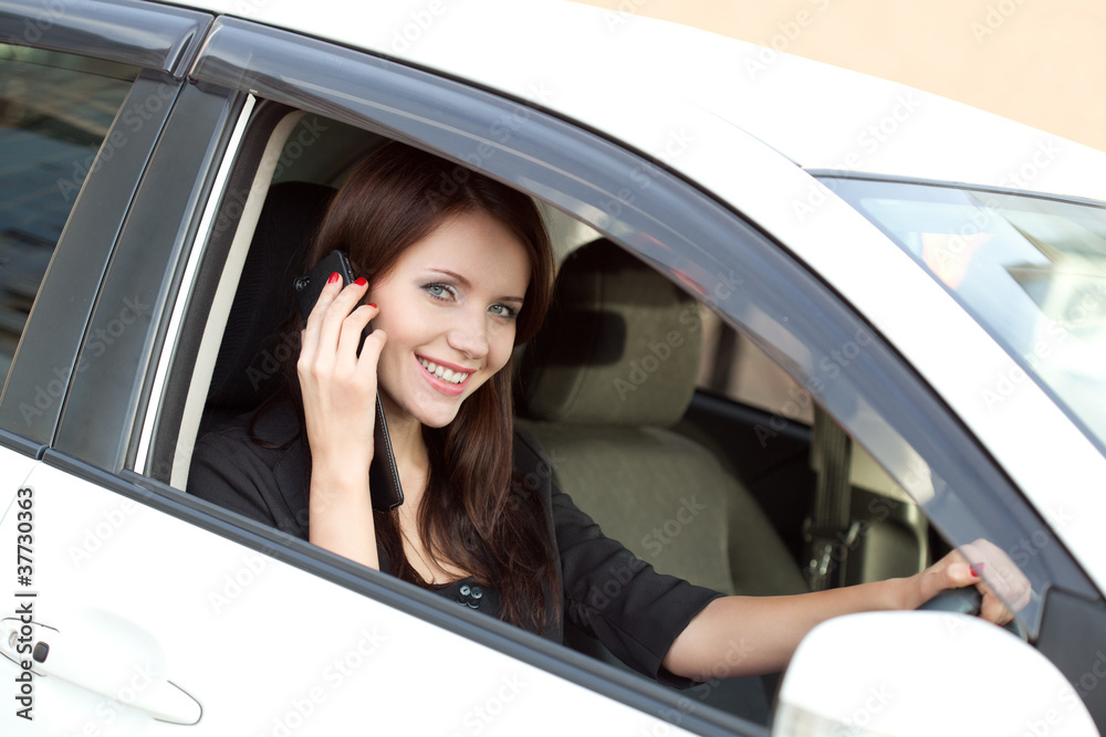 brunette woman in car calling