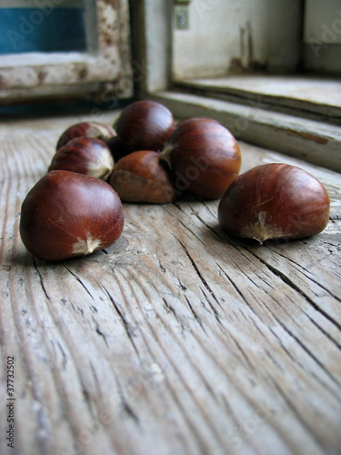 Pile of chestnuts on an old retro window sill