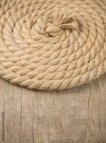 ship ropes and knot on wood