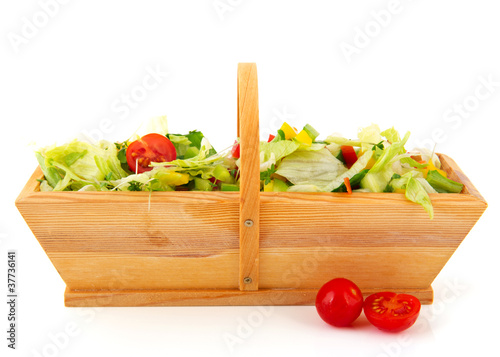 Fresh mixed salad in wooden basket