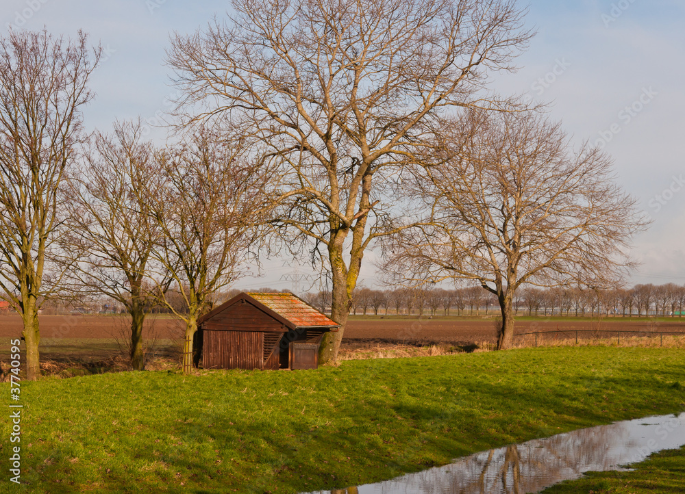 Small wooden shed in a Dutch winter landscape Small wooden shed in a Dutch winter landscape