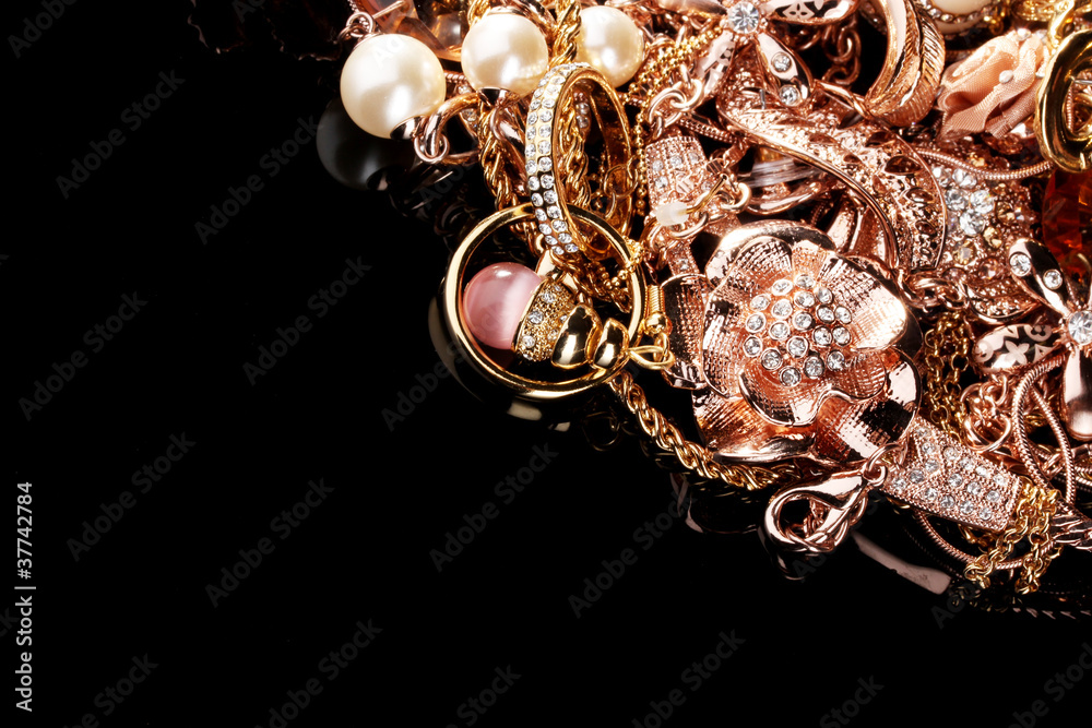 Various gold jewellery on black Various gold jewellery on black