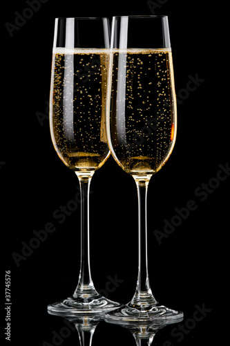 Two glasses of champagne on  black background