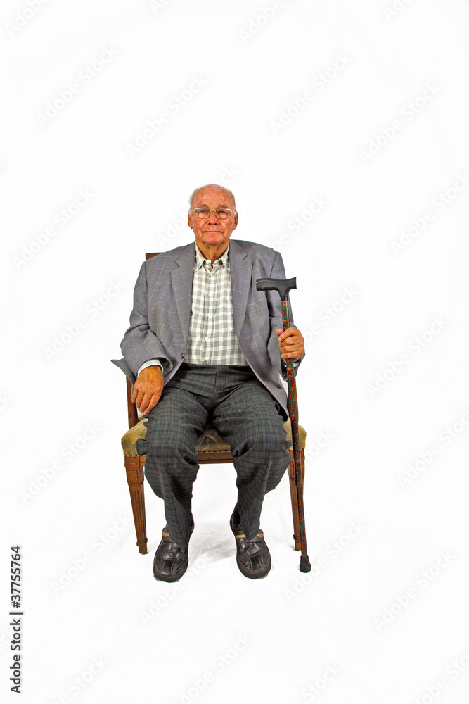 old man sitting in the armchair with his walking stick old man sitting in the armchair with his walking stick