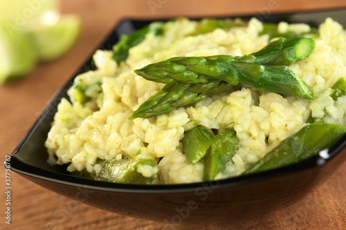 Green asparagus risotto in black bowl