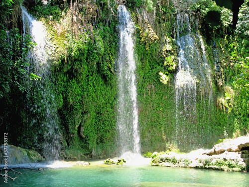 Fototapeta Naklejka Na Ścianę i Meble -  waterfall falling into blue lagoon in tropical deep forest