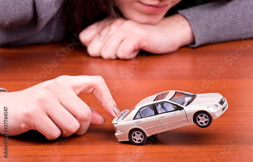 Woman's hand holding the model of car