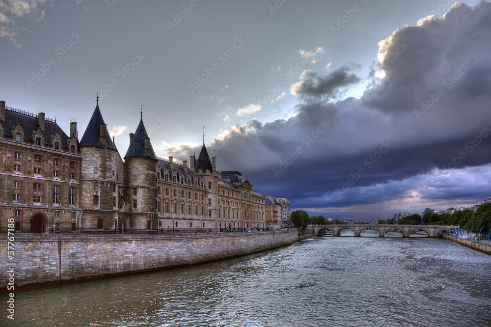 Conciergerie before rain in Paris, dramatic cloudscape.