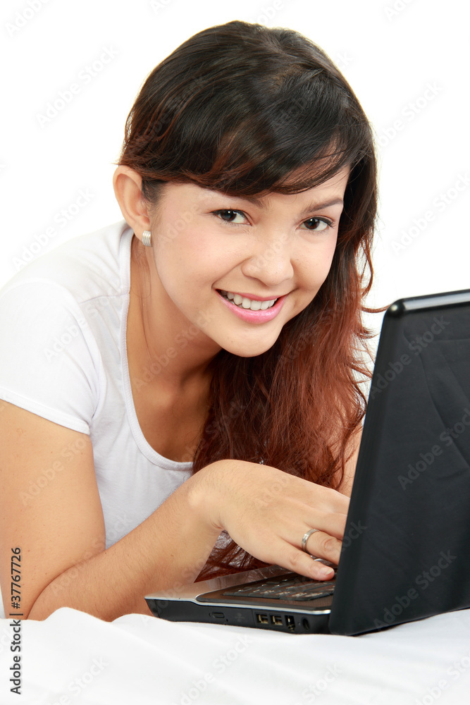 woman lying in bed browsing internet with laptop woman lying in bed browsing internet with laptop