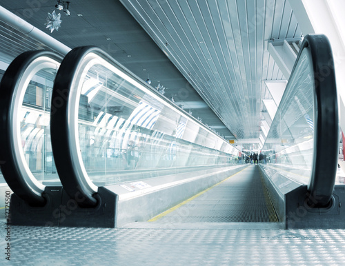abstract composition of motion metro escalator in glass corridor