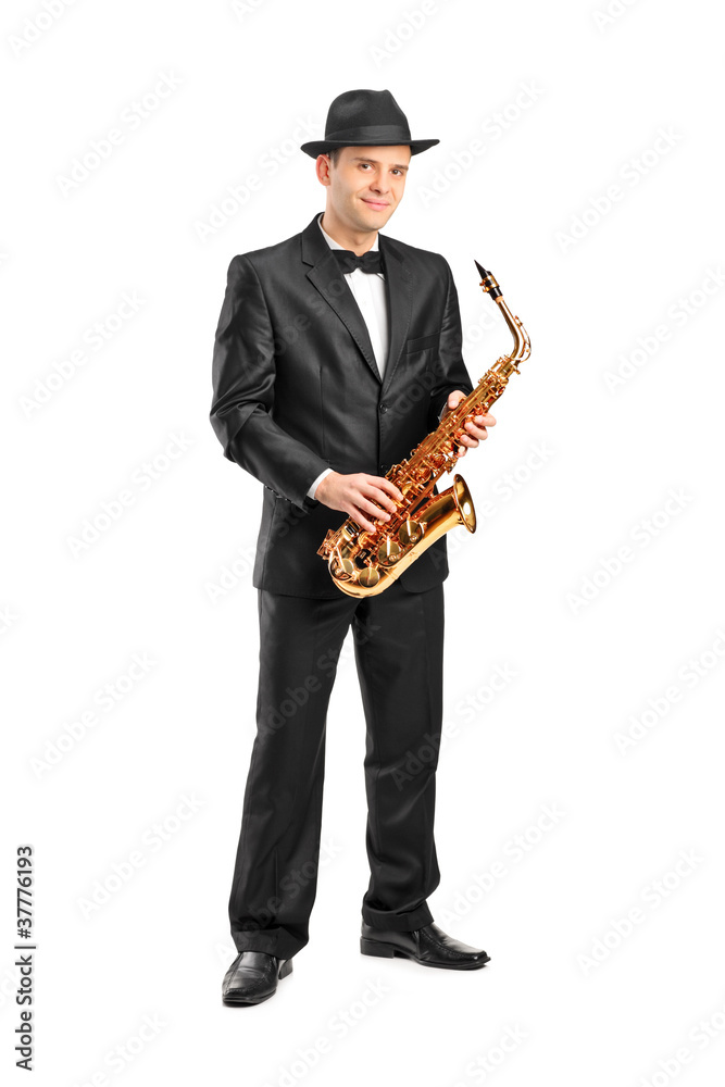 Naklejka premium Full length portrait of a man in a suit holding a saxophone