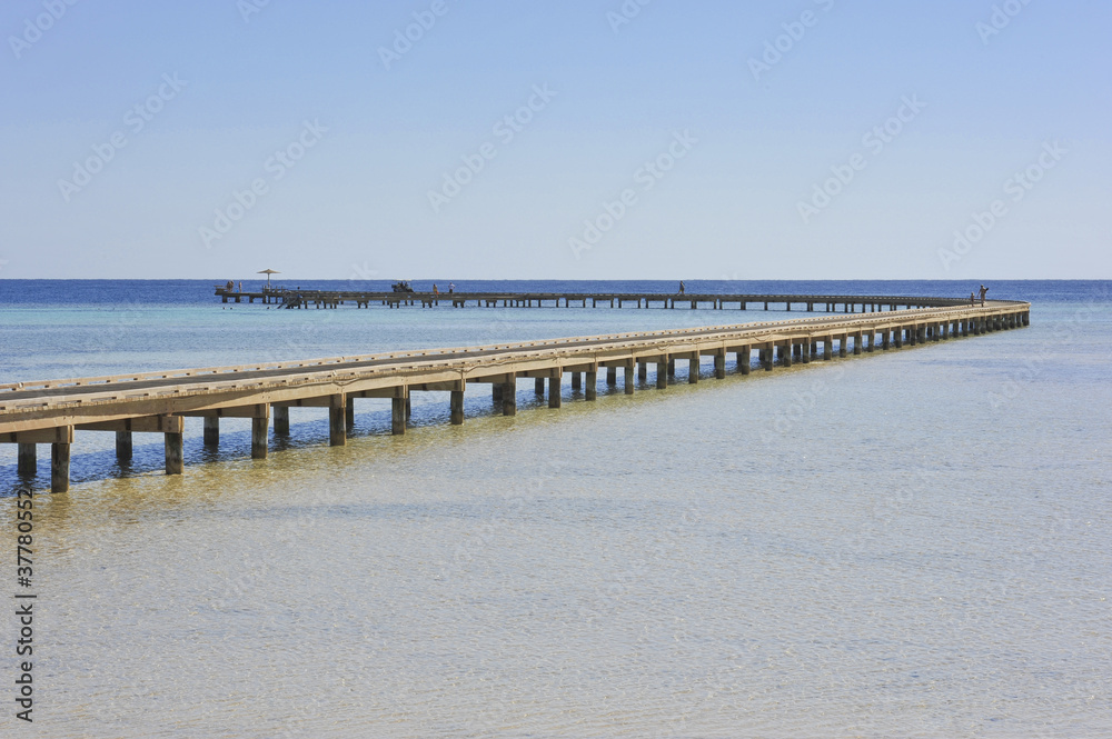 Long jetty over coral reef