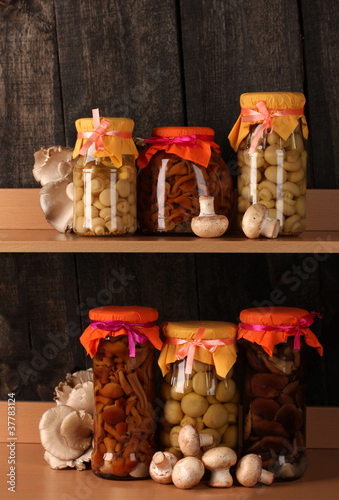 delicious marinated mushrooms in the glass jars, raw