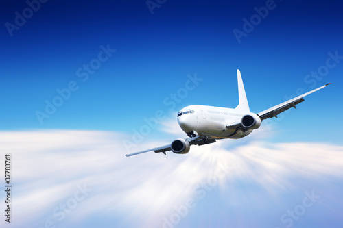 Jet plane flying above clouds